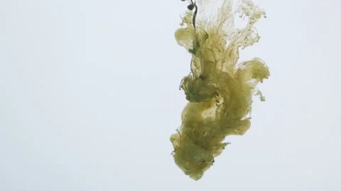Green paint explodes and sprays in the water on a white background Video stock 154374588