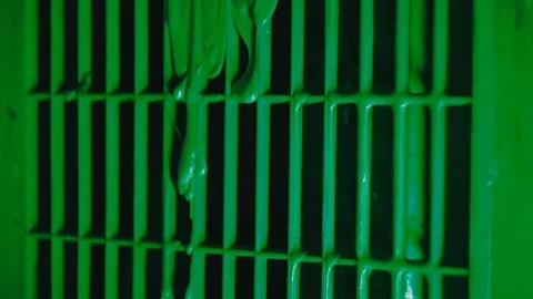 Green paint flows down the grate Stock Footage 81700738
