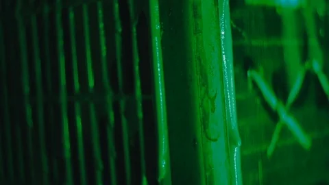 Green paint flows slowly down the grate Stock Footage 81700372