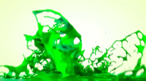 Green paint splashing, isolated on bright backgorund Stock Footage 38908467