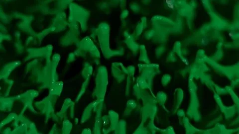 Green paint splatter background; macro texture Stock Photos