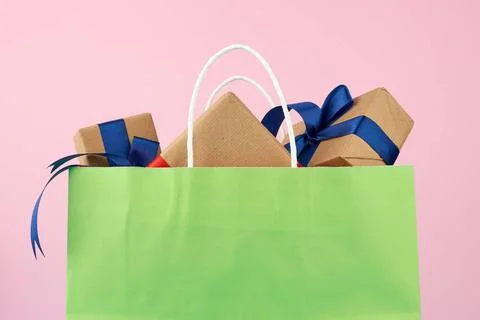 Green paper bag with a gift box green paper bag with a gift box, concept o... Stock Photos