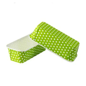 Green paper baking forms for cakes with dotted pattern Stock Photos