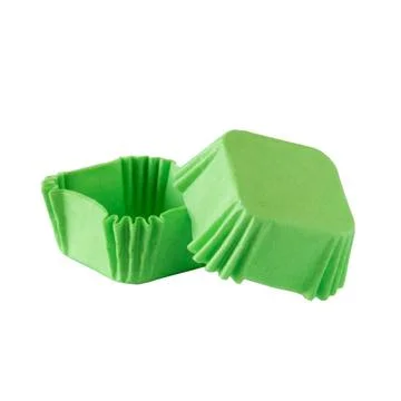 Green paper baking forms for muffins and cupcakes Stock Photos