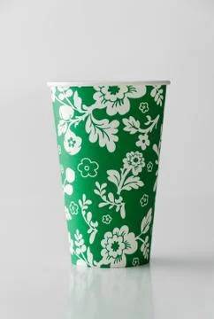 Green paper cup with flowers pattern Stock Photos