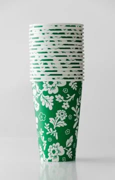 Green paper cup with flowers pattern Stock Photos