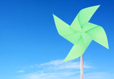 Green paper windmill in the sky Stock Photos