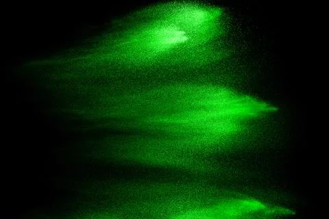Green particles explosion on black background. Color dust splash use for ab.. Stock Illustration