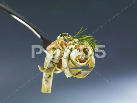 Green pasta with salmon and herb sauce Stock Photos