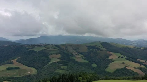Green patchwork pasture land on lush forested hillsides of Ispoure FRA Stock Footage 314366471