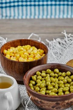 Green pea and corn beans in wooden cups Stock Photos