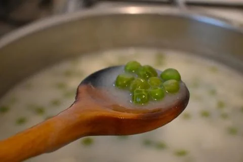 Green pea stew on a spoon Photos