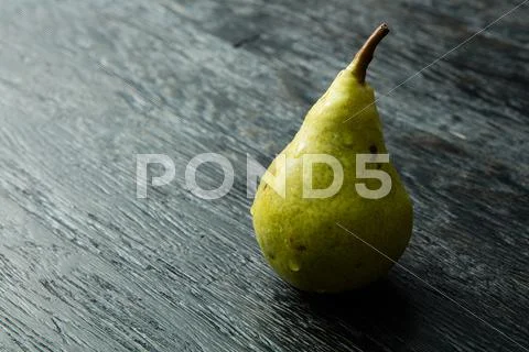 Green pear on a dark background Stock Photos