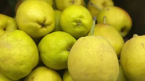 Green pears close-up on shelf showing smooth texture Stock Footage 314098156