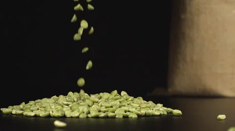 A green peas fall in a pile on a table near a bag Stock Footage 59018874
