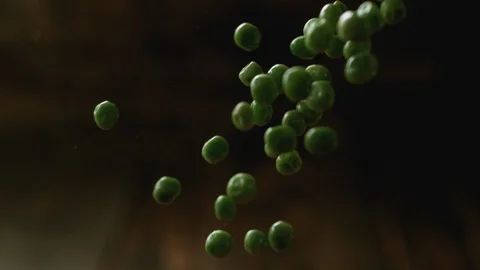 Green peas falling. Slow Motion. Stock Footage 89810597