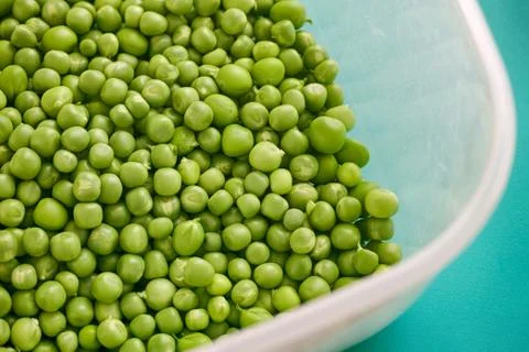 Green peas in a plastic container Stock Photos