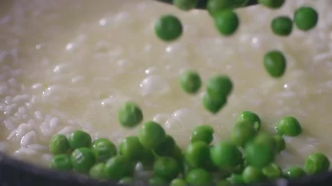 Green peas with rice cooked at the pan, close-up slow motion Video stock 152154374