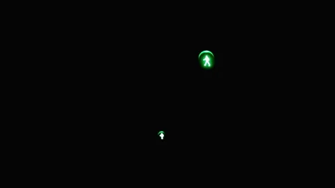Green pedestrian traffic light with walking man icon at night Stock Footage 330875675