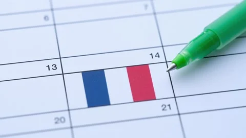 A green pen points to the Bastille Day date of July 14th Stock Footage 338246564