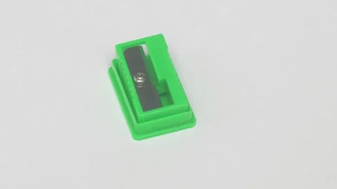 A Green Pencil Sharpener Positioned Against a Clean White Background for an Stockbeeldmateriaal 283639493