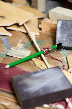 Green pencil with string on workbench, woodworking tools concept. Stock Photos