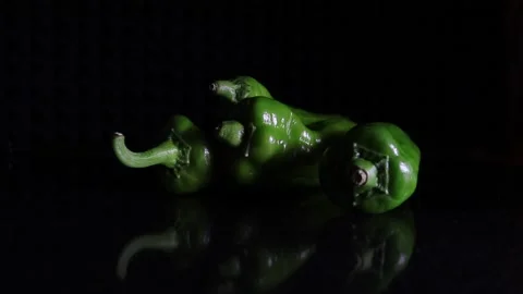 Green pepper on black reflective surface Stock Footage 158149218
