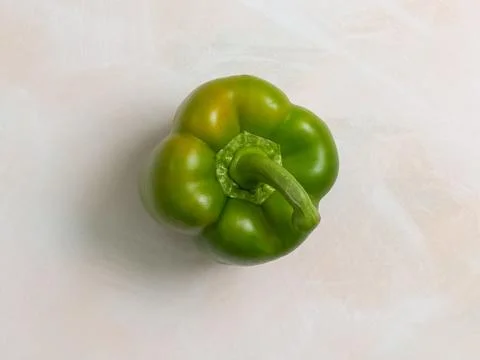 Green pepper, one, light background, photo from above, vegetarian food Stock Photos