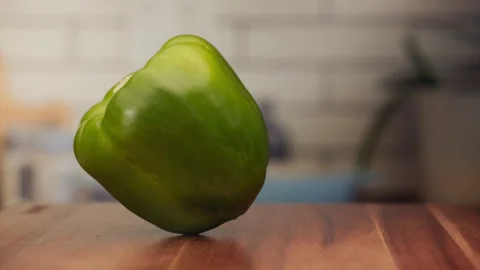 Green pepper spinning on a table in slow motion Stock Footage 152905345
