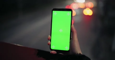 Green phone screen on the background of driving cars Stock Footage 146482378
