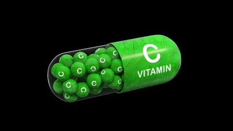 Green pill or capsule filled with vitamin C. black back. Alpha channel. Stock Footage 286233783