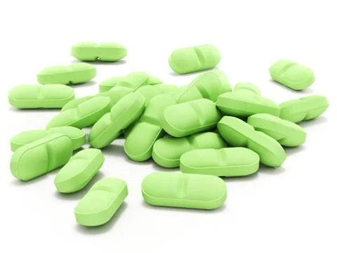 Green pills on white background Illustrazione stock