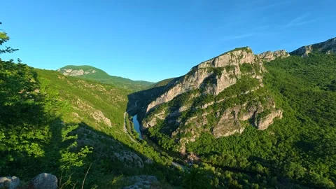 Green pine needles frame a sunlit mountain valley. Sicevo Gorge, Serbia. Stock Footage 337052347