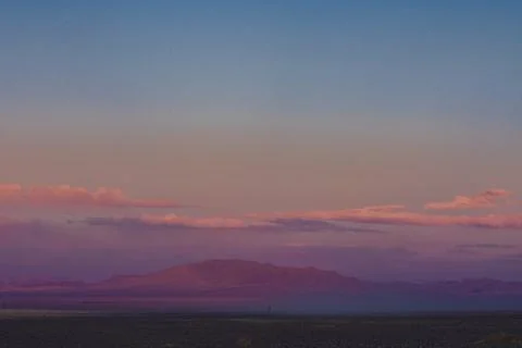 Green plain at root of mountains Stock Photos