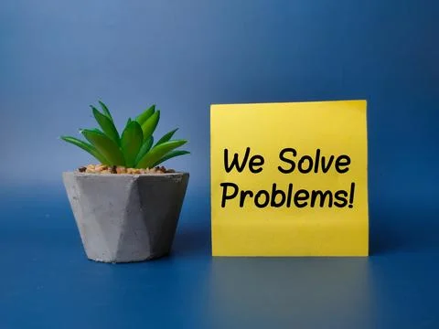 Green plan and sticky note with the word We Solve Problems Stock Photos