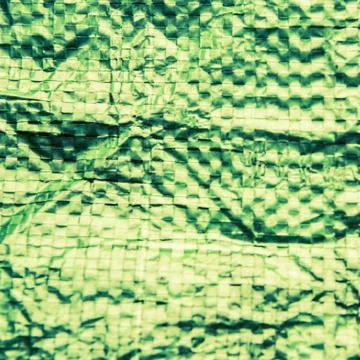 A green plastic bag texture, macro, background Stock Photos