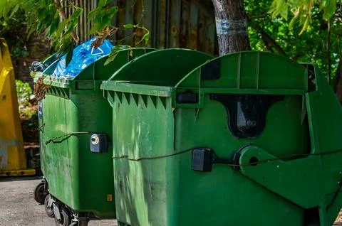 Green plastic bins for garbage waste on the street. Stock Photos