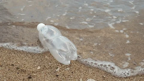 Green plastic bottle on the beach. Stock Footage 154402825
