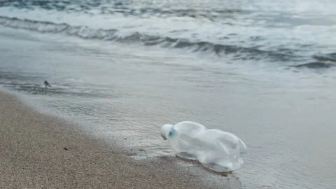 Green plastic bottle on the beach. Stock Footage 154405179