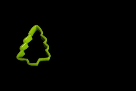Green plastic cookie cutter for making cookies in the form of a Christmas tre Stock Photos