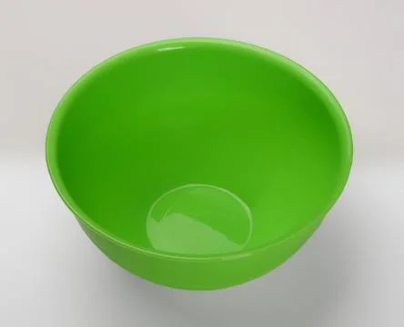 Green plastic deep dish isolated on wjite background Фото
