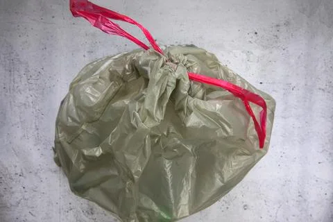 Green plastic garbage bag for plastic waste, ready to recycle, waste management Stock Photos