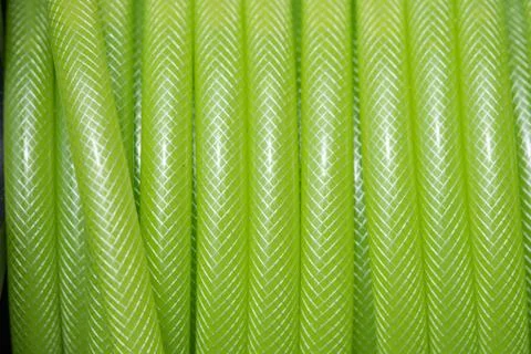 Green plastic rubber strap water for plants Stock Photos