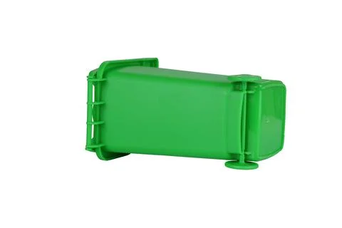 Green plastic trash bin isolated on white background, lying on side 写真素材