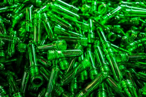 Green plastic tubes that will be future beverage bottles. Stock Photos