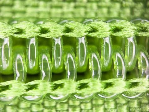 Green plastic zipper under a microscope, macro shot of lightning Fotos de archivo