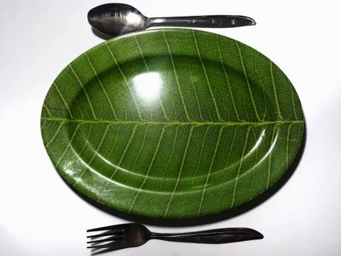 Green plate leaf theme isolated white background with spoon and fork 스톡 사진