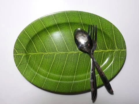 Green plate leaf theme isolated white background with spoon and fork 스톡 사진