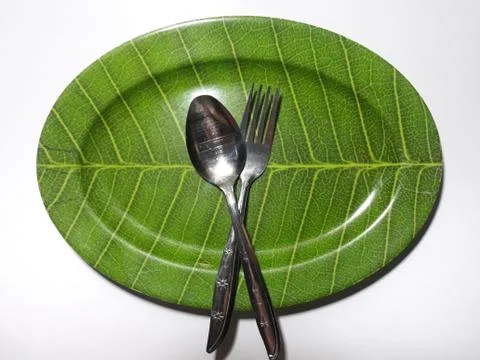 Green plate leaf theme isolated white background with spoon and fork 스톡 사진
