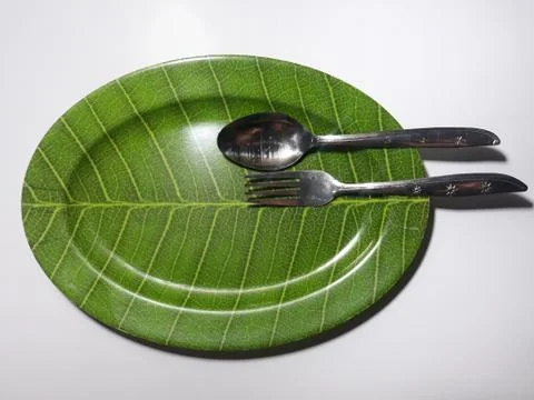Green plate leaf theme isolated white background with spoon and fork 스톡 사진